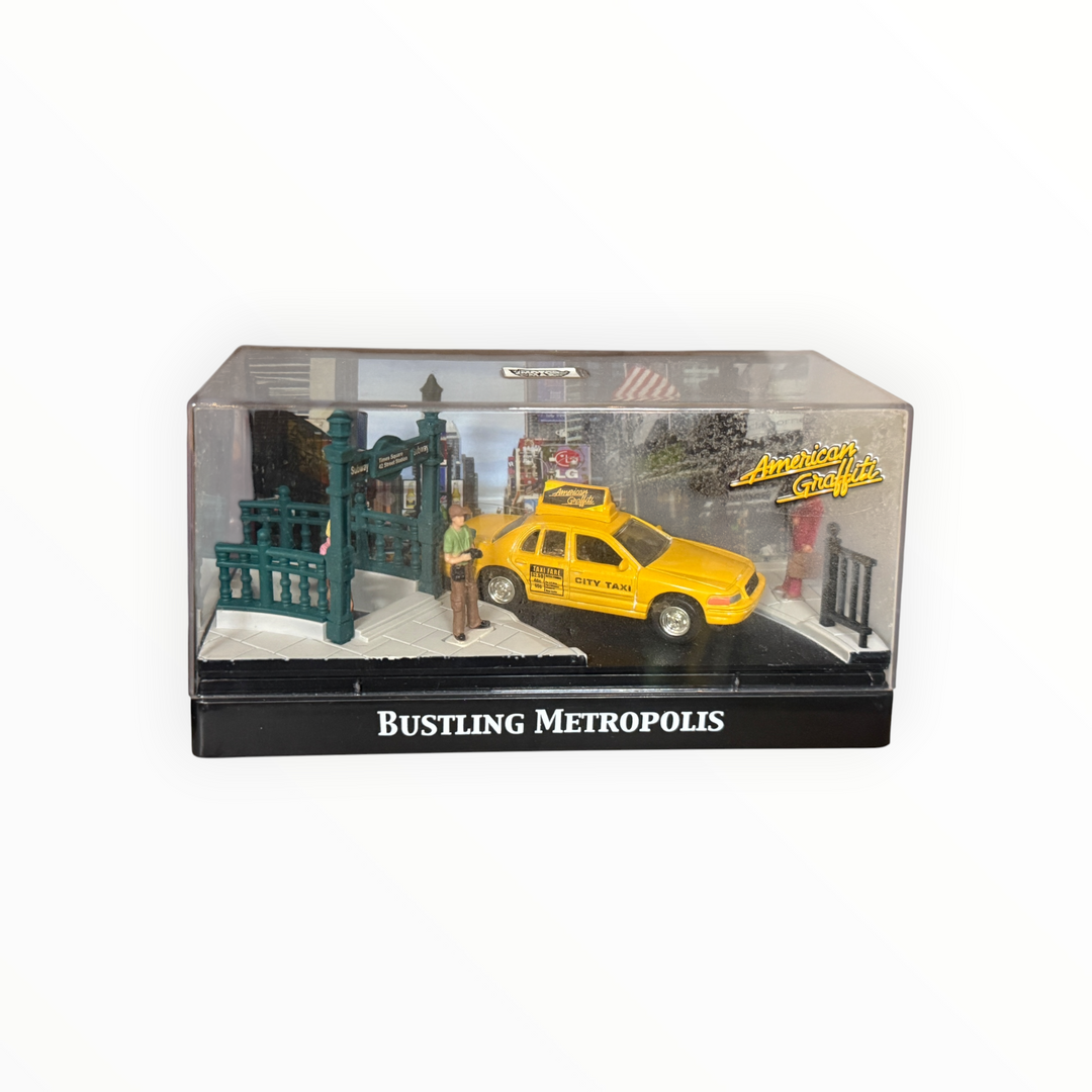 Motor Max "American Graffiti: Bustling Metropolis" diorama set featuring a yellow Ford Crown Victoria taxi