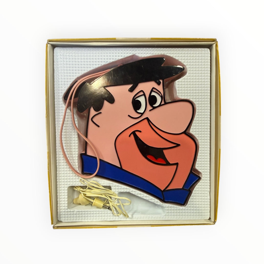 Vintage Fred Flintstone transistor radio from 1972, manufactured by Hanna-Barbera Productions