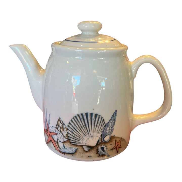 Teapot with seashell decals.